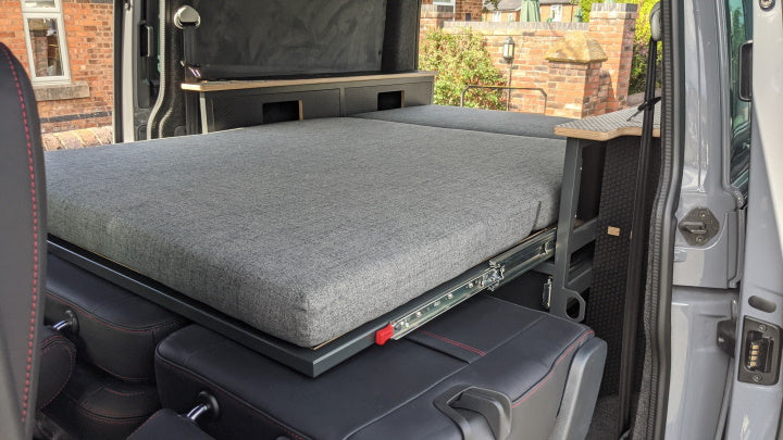 pull-out bed in a van with rear seats